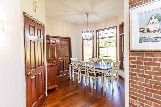 dining area featuring a notable chandelier and dark hardwood / wood-style floors