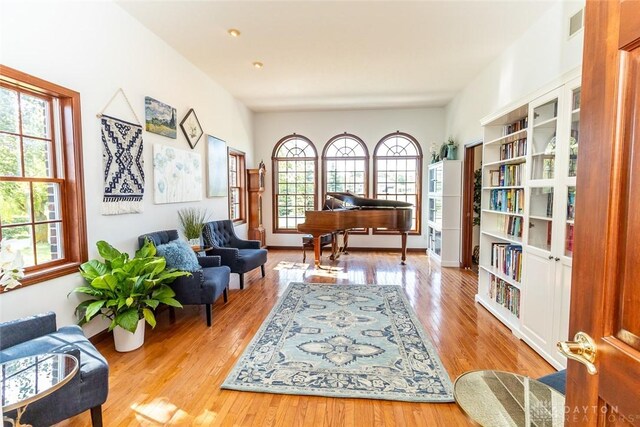 living area with plenty of natural light and light hardwood / wood-style floors