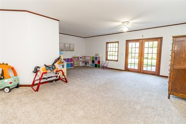 recreation room featuring ceiling fan, french doors, carpet floors, and crown molding