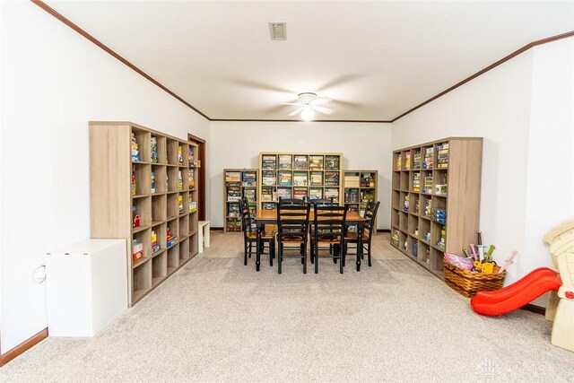 dining room featuring carpet floors, ceiling fan, and crown molding