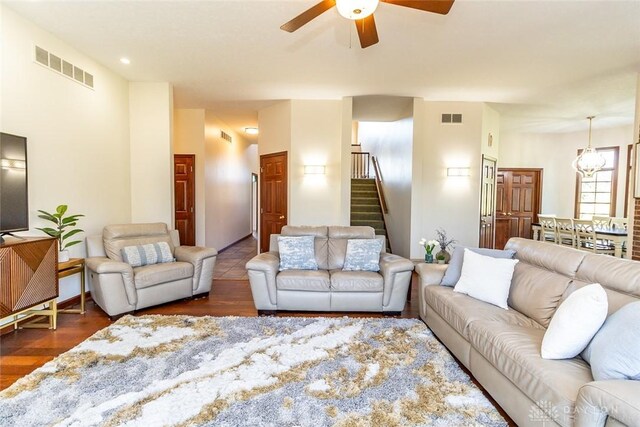 living room with dark hardwood / wood-style floors and ceiling fan