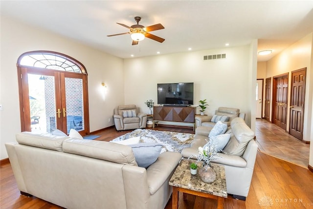 living room featuring ceiling fan, french doors, and hardwood / wood-style flooring