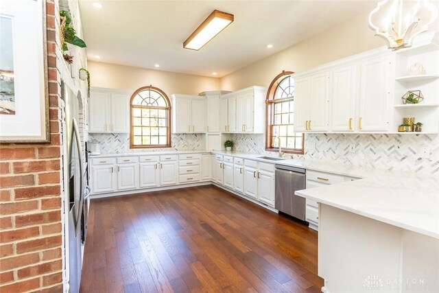 kitchen featuring white cabinetry, stainless steel dishwasher, a wealth of natural light, and dark wood-type flooring