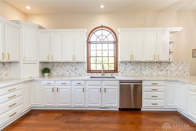 kitchen featuring sink, white cabinets, stainless steel dishwasher, and dark hardwood / wood-style floors