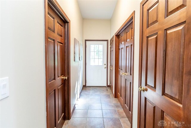 doorway to outside with light tile patterned floors