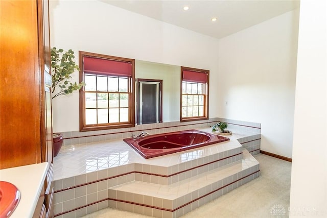 bathroom featuring a relaxing tiled tub