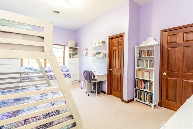 bedroom featuring light colored carpet