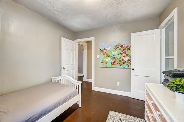 bedroom with hardwood / wood-style flooring and a textured ceiling