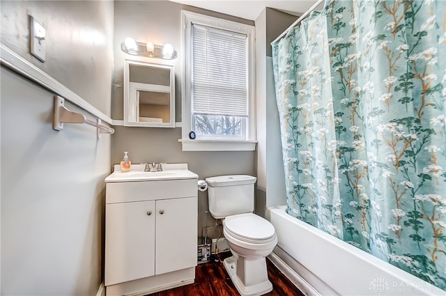 full bathroom featuring wood-type flooring, shower / bath combo with shower curtain, vanity, and toilet