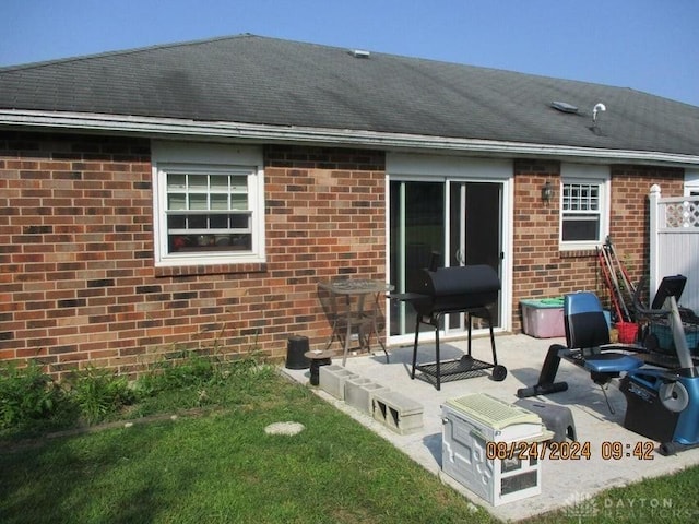 back of house featuring a yard and a patio