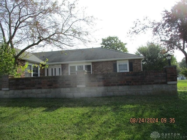 back of property with a lawn