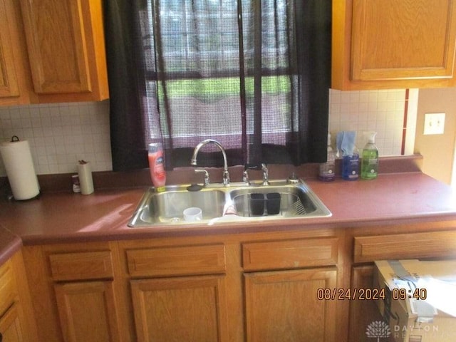 kitchen featuring tasteful backsplash and sink