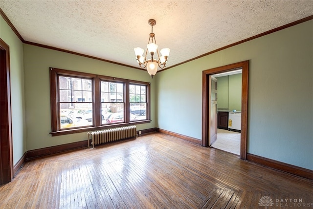 unfurnished room with a textured ceiling, radiator heating unit, a chandelier, and parquet flooring