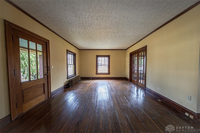 foyer entrance featuring dark hardwood / wood-style floors, a textured ceiling, and radiator