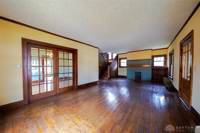 unfurnished living room featuring a fireplace, hardwood / wood-style floors, radiator heating unit, and a textured ceiling