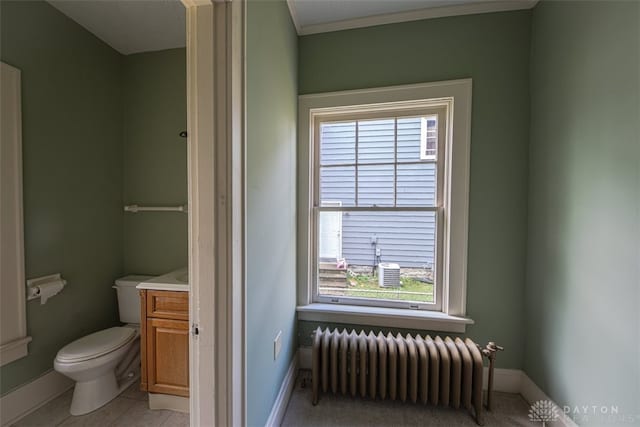 bathroom with tile patterned floors, toilet, radiator heating unit, and vanity