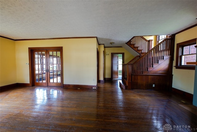 unfurnished living room featuring a wealth of natural light, crown molding, hardwood / wood-style flooring, and french doors