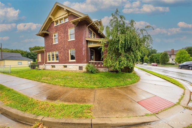 view of side of home featuring a lawn