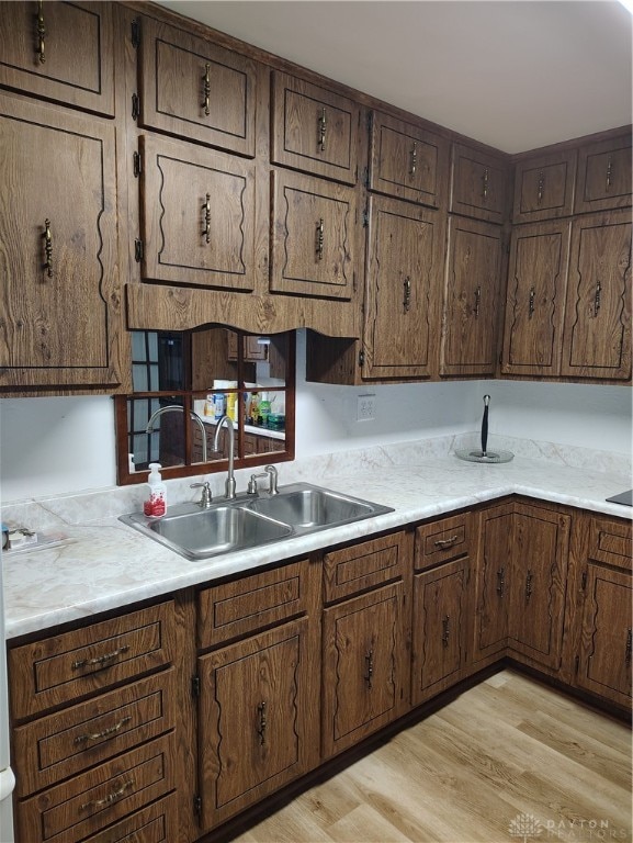 kitchen with sink and light hardwood / wood-style flooring