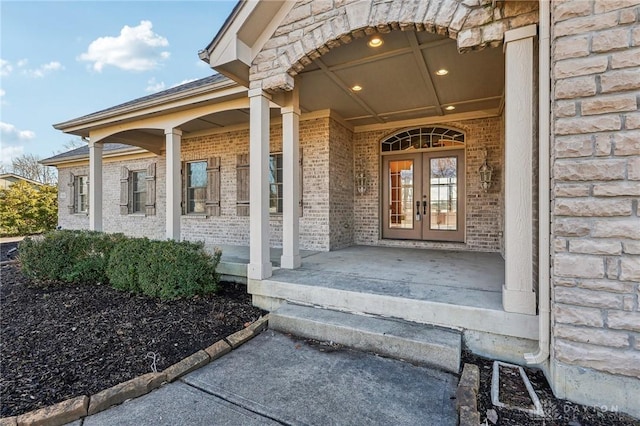 property entrance featuring covered porch and french doors