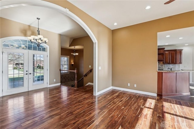 interior space featuring a chandelier, french doors, and dark hardwood / wood-style flooring