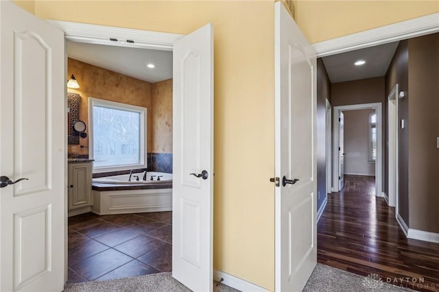 hallway with dark tile patterned flooring