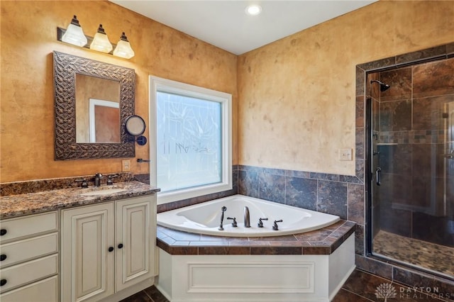 bathroom with vanity and independent shower and bath