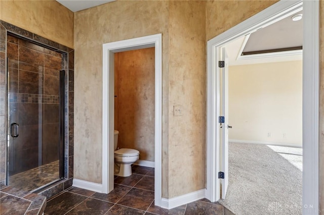 bathroom with toilet and a shower with shower door