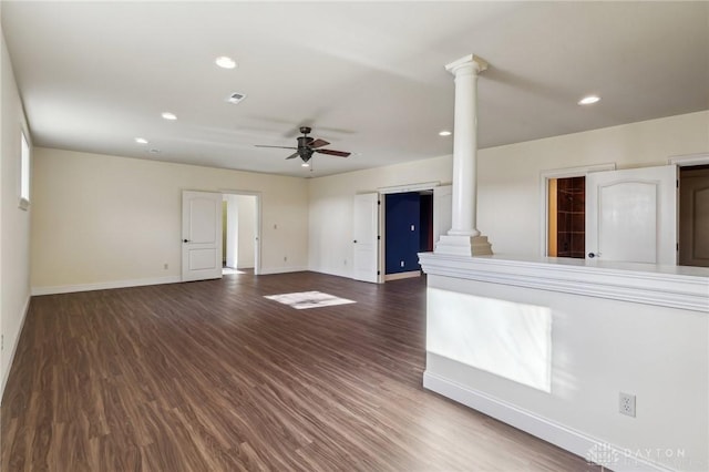 unfurnished living room featuring dark hardwood / wood-style floors, ornate columns, and ceiling fan