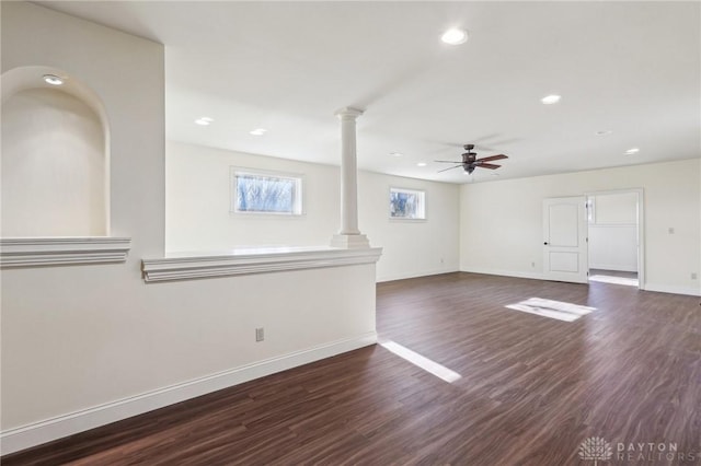 unfurnished living room with decorative columns, ceiling fan, and dark wood-type flooring