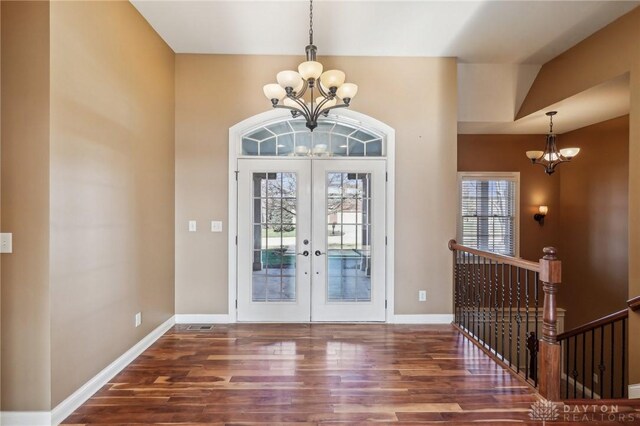 foyer featuring a chandelier, french doors, and dark hardwood / wood-style floors