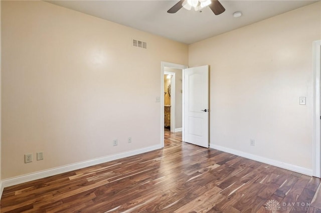 empty room featuring dark hardwood / wood-style floors and ceiling fan