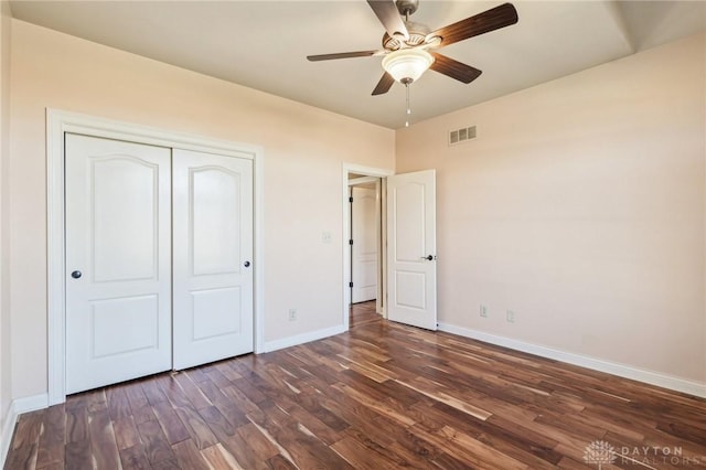 unfurnished bedroom featuring a closet, ceiling fan, and dark wood-type flooring