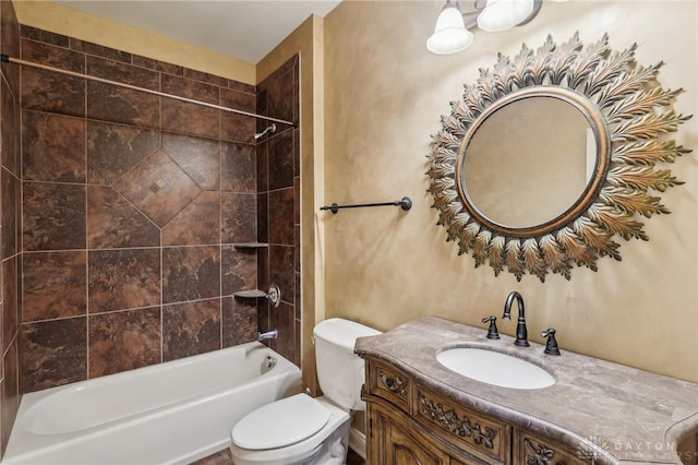 full bathroom with vanity, toilet, and tiled shower / bath