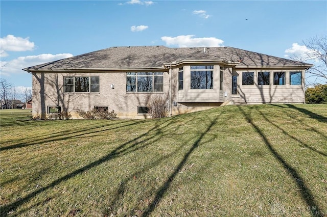 rear view of property with a lawn