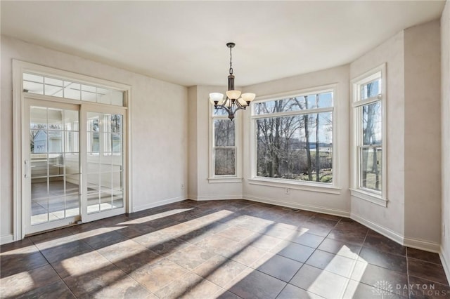 unfurnished dining area featuring a chandelier