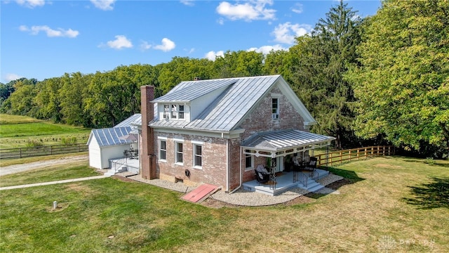 back of property featuring a lawn and a patio area