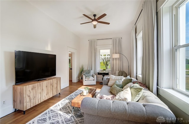 living room featuring ceiling fan and light hardwood / wood-style floors