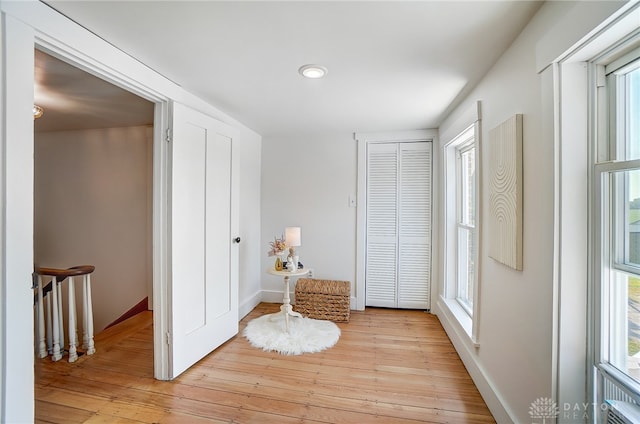 interior space with plenty of natural light and light hardwood / wood-style flooring