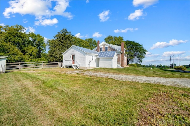 view of side of property featuring a lawn