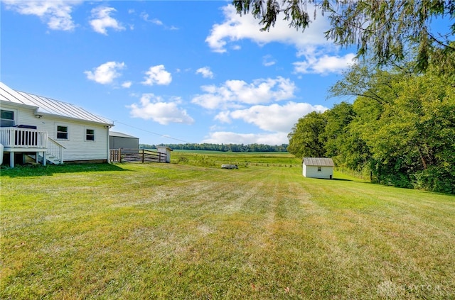 view of yard featuring an outbuilding and a rural view