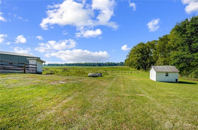 view of yard with an outbuilding and a rural view