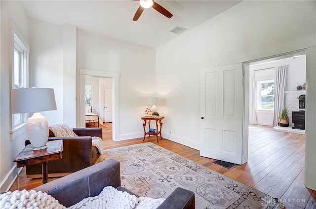 living room featuring ceiling fan and light hardwood / wood-style floors