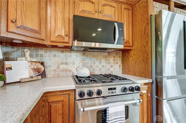 kitchen featuring appliances with stainless steel finishes and backsplash