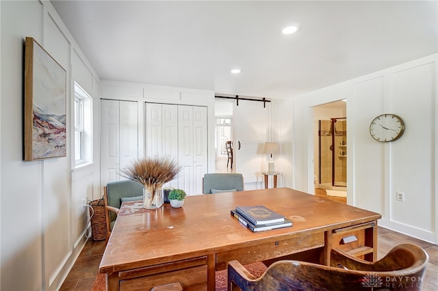 office space featuring tile patterned flooring and a barn door