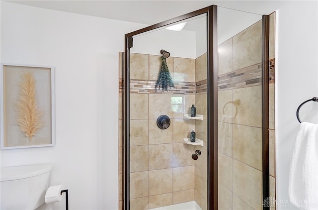 bathroom featuring toilet and an enclosed shower