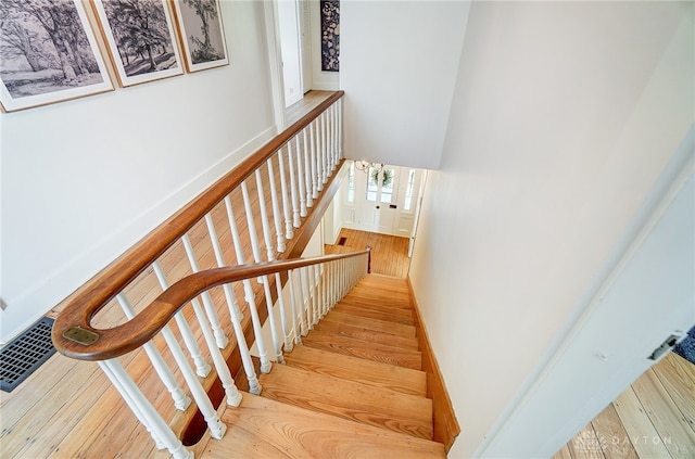 stairs featuring hardwood / wood-style floors