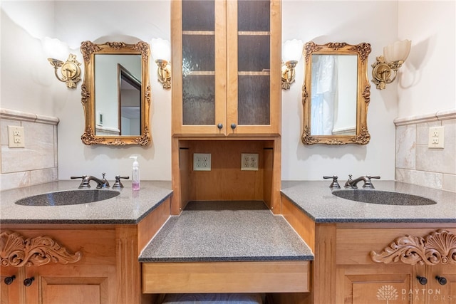 bathroom featuring vanity and backsplash