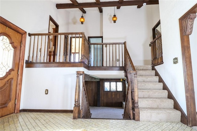 entrance foyer featuring beam ceiling