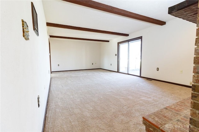 unfurnished room featuring beam ceiling and light colored carpet